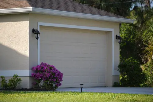 Wide garage double door and concrete driveway of new modern american house